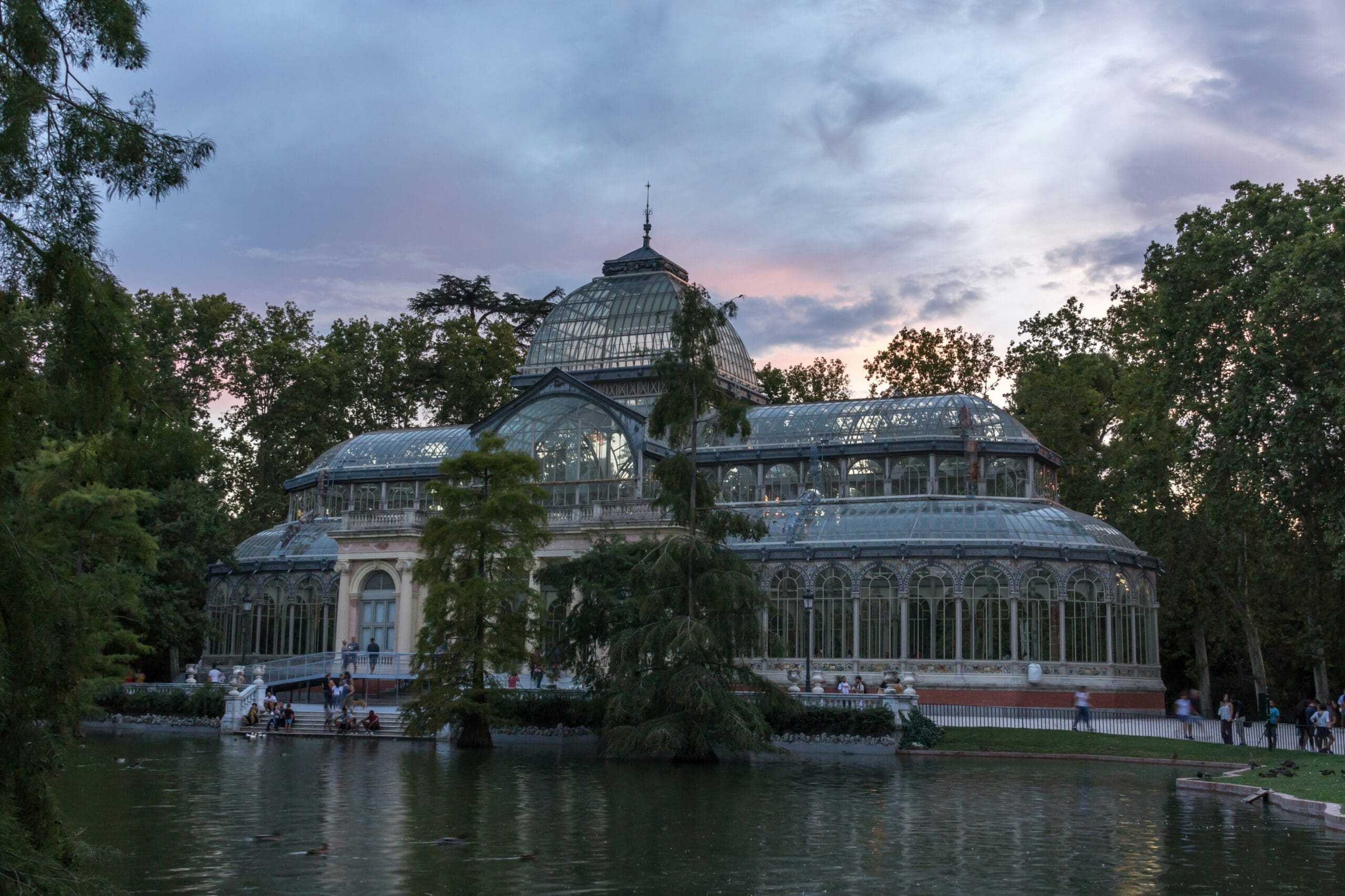 The glass Palacio de Cristal, surrounded by trees