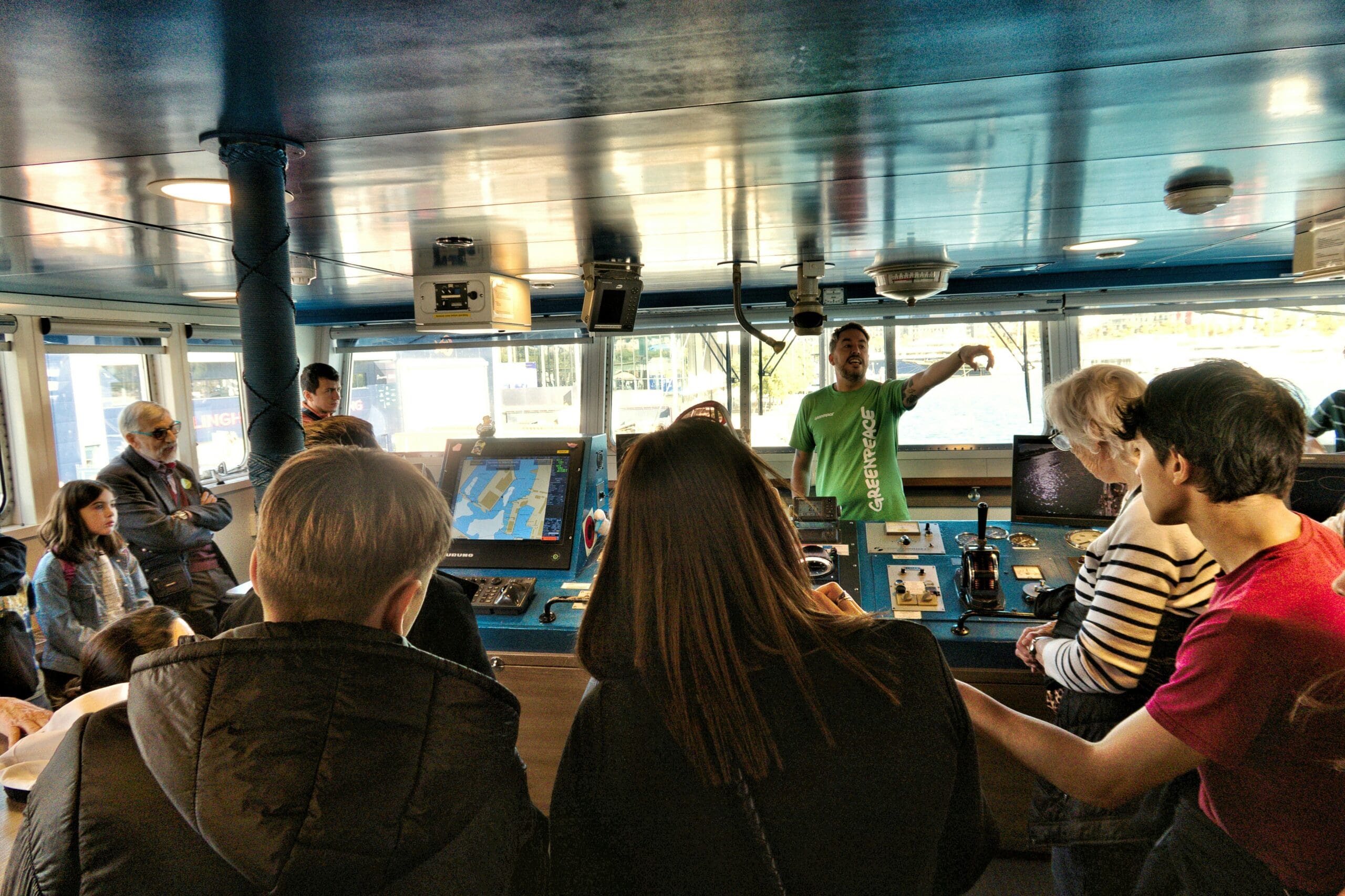 A guide explains a work of art to a group of visitors.