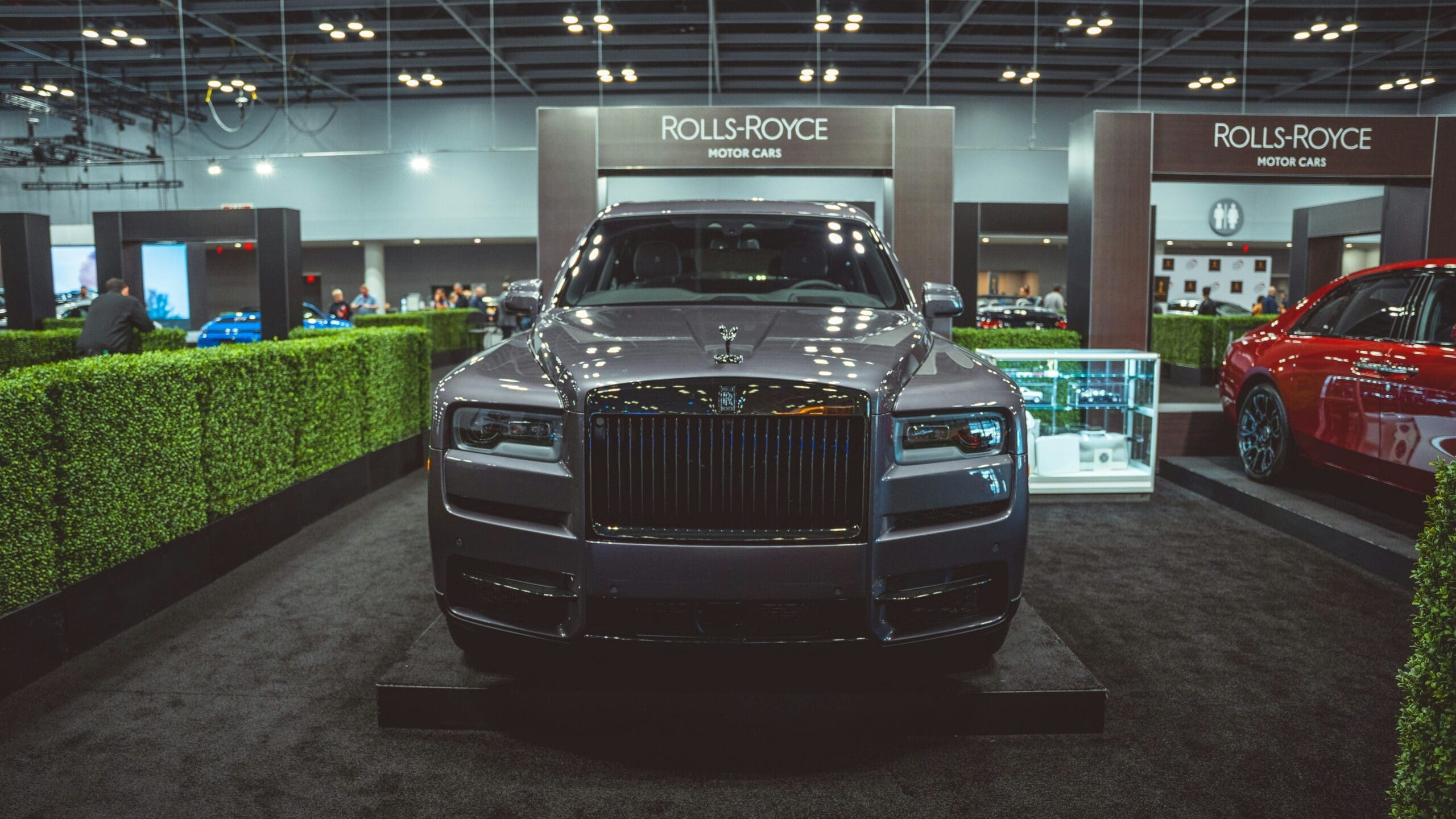 Visitors admiring a Rolls-Royce model