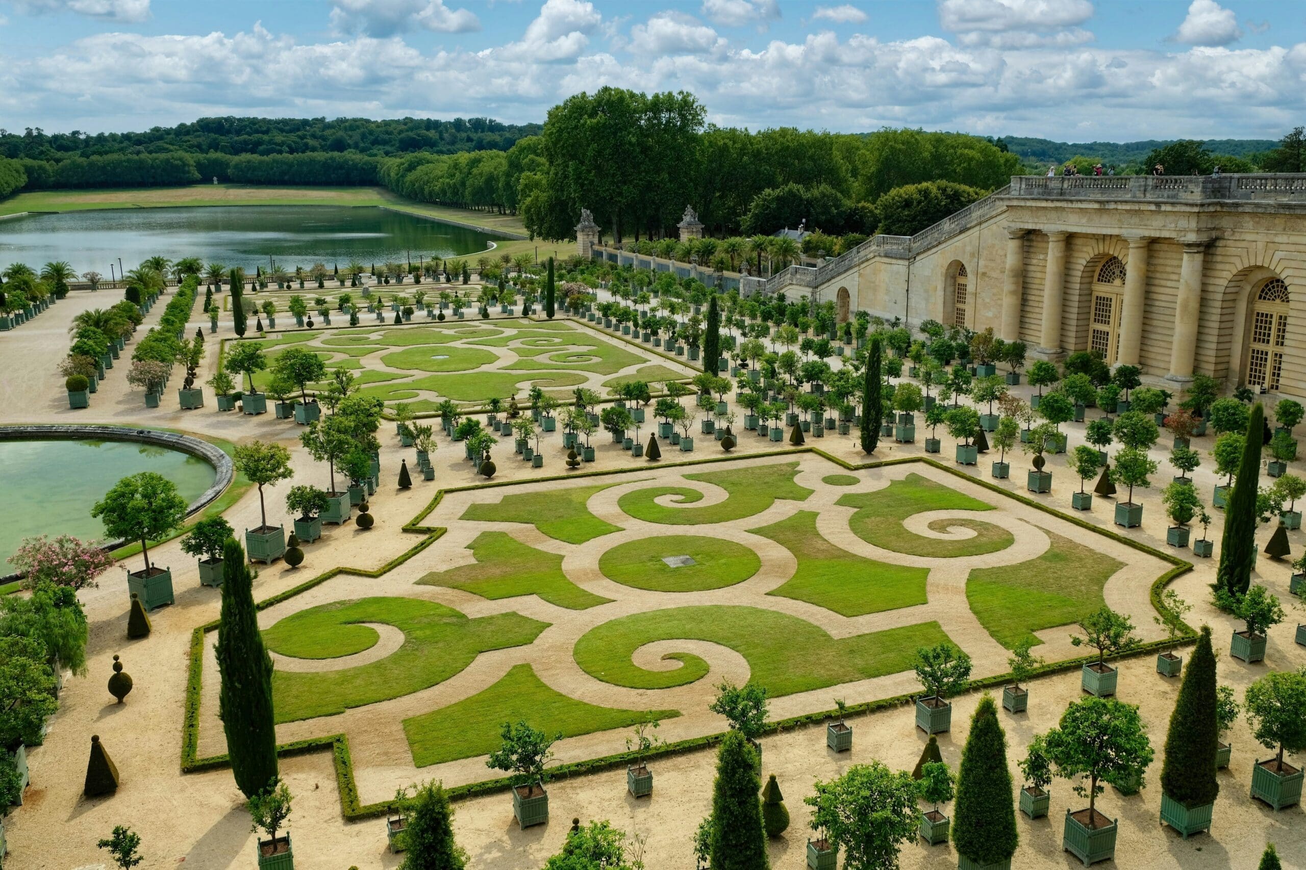 The picturesque Grand Canal of the Versailles Gardens under a blue sky
